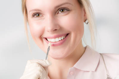 woman selecting a color for dental veneers