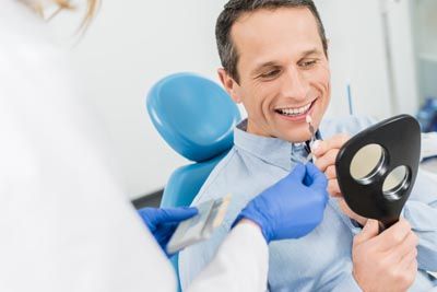 man choosing a color for dental veneers